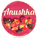 Beautifully decorated red velvet berry birthday cake with vibrant fruits and a glowing 'Anushka' name, adding a touch of sweetness and sparkle.