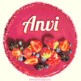 Beautifully decorated red velvet berry birthday cake with vibrant fruits and a glowing 'Anvi' name, adding a touch of sweetness and sparkle.