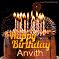A rich chocolate cake topped with glowing birthday candles and surrounded by bright fireworks. The animated GIF displays the message 'Happy Birthday Anvith' in golden text.
