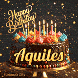 Multi-colored dollops of frosting and burning birthday candles on a chocolate glaze cake, custom-designed for Aquiles.