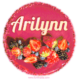 Beautifully decorated red velvet berry birthday cake with vibrant fruits and a glowing 'Arilynn' name, adding a touch of sweetness and sparkle.