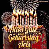 A chocolate birthday cake with glowing candles, the German text 'Alles Gute zum Geburtstag Aris,' and vibrant fireworks lighting up the background in an animated GIF.