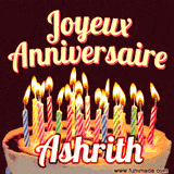 A Happy Birthday GIF in French featuring a festive birthday cake adorned with bright candles and the glowing text 'Joyeux Anniversaire Ashrith' in a cheerful style.