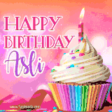 A vibrant birthday GIF featuring a rainbow-colored cupcake topped with white frosting, sprinkles, and a lit candle. The text reads 'Happy Birthday Asli' in bold pink and violet letters with white outline.