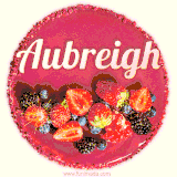 Beautifully decorated red velvet berry birthday cake with vibrant fruits and a glowing 'Aubreigh' name, adding a touch of sweetness and sparkle.