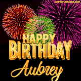 A golden 'Happy Birthday Aubrey' message with vibrant fireworks in the background, creating a festive and celebratory vibe in this animated name GIF.