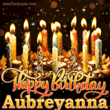 A glowing personalized birthday GIF with name Aubreyanna featuring lit candles with intricate designs, warm lighting, and the text 'Happy Birthday' in an elegant font.