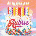 Personalized for Aubrie elegant birthday cake adorned with rainbow sprinkles, colorful candles and glitter