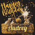 Celebrate Audrey's birthday with a GIF featuring chocolate cake, a lit sparkler, and golden stars