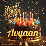 Gold Happy Birthday topper and bright burning candles on a chocolate frosted cake with the name Avyaan.
