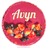 Beautifully decorated red velvet berry birthday cake with vibrant fruits and a glowing 'Avyn' name, adding a touch of sweetness and sparkle.