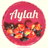 Beautifully decorated red velvet berry birthday cake with vibrant fruits and a glowing 'Aylah' name, adding a touch of sweetness and sparkle.