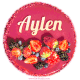 Beautifully decorated red velvet berry birthday cake with vibrant fruits and a glowing 'Aylen' name, adding a touch of sweetness and sparkle.