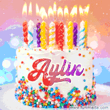 A cheerful white birthday cake with multicolor sprinkles, lit candles, and 'Aylin' written in vibrant letters, in an animated GIF.