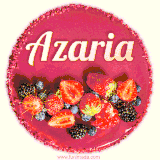 Beautifully decorated red velvet berry birthday cake with vibrant fruits and a glowing 'Azaria' name, adding a touch of sweetness and sparkle.