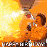 Funny animation of a birthday fail. A huge burst of orange and yellow flames erupts from a cake as a woman blows powder on the candles. Text reads HAPPY BIRTHDAY! below the fire.