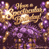 Golden glittery Have a Spectacular Birthday lettering shines above a box of purple and lavender roses with a purple bow while purple and gold balloons float amid bright fireworks on a reflective surface