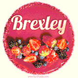 Beautifully decorated red velvet berry birthday cake with vibrant fruits and a glowing 'Brexley' name, adding a touch of sweetness and sparkle.