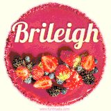 Beautifully decorated red velvet berry birthday cake with vibrant fruits and a glowing 'Brileigh' name, adding a touch of sweetness and sparkle.