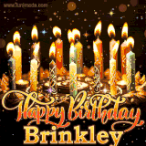 A glowing personalized birthday GIF with name Brinkley featuring lit candles with intricate designs, warm lighting, and the text 'Happy Birthday' in an elegant font.