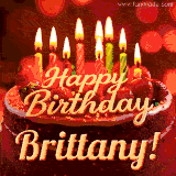 Beautifully decorated red velvet berry birthday cake with vibrant fruits and a glowing 'Brittany' name, adding a touch of sweetness and sparkle.
