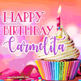 A vibrant birthday GIF featuring a rainbow-colored cupcake topped with white frosting, sprinkles, and a lit candle. The text reads 'Happy Birthday Carmelita' in bold pink and violet letters with white outline.