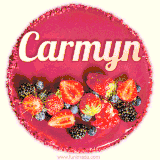 Beautifully decorated red velvet berry birthday cake with vibrant fruits and a glowing 'Carmyn' name, adding a touch of sweetness and sparkle.