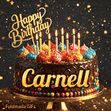 A chocolate drip birthday cake on a stand with colorful frosting and lit candles, featuring the name Carnell in glowing yellow letters.
