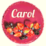 Beautifully decorated red velvet berry birthday cake with vibrant fruits and a glowing 'Carol' name, adding a touch of sweetness and sparkle.