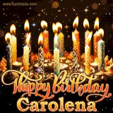A glowing personalized birthday GIF with name Carolena featuring lit candles with intricate designs, warm lighting, and the text 'Happy Birthday' in an elegant font.