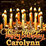 A glowing personalized birthday GIF with name Carolynn featuring lit candles with intricate designs, warm lighting, and the text 'Happy Birthday' in an elegant font.