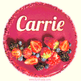 Beautifully decorated red velvet berry birthday cake with vibrant fruits and a glowing 'Carrie' name, adding a touch of sweetness and sparkle.