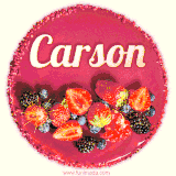 Beautifully decorated red velvet berry birthday cake with vibrant fruits and a glowing 'Carson' name, adding a touch of sweetness and sparkle.