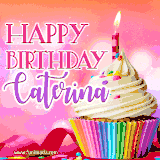 A vibrant birthday GIF featuring a rainbow-colored cupcake topped with white frosting, sprinkles, and a lit candle. The text reads 'Happy Birthday Caterina' in bold pink and violet letters with white outline.