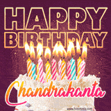 A colorful birthday cake topped with lit candles, with the words 'Happy Birthday Chandrakanta' in bold glowing letters on a burgundy background. Animated flames add a festive touch.