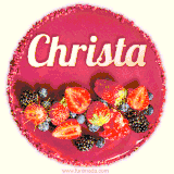Beautifully decorated red velvet berry birthday cake with vibrant fruits and a glowing 'Christa' name, adding a touch of sweetness and sparkle.