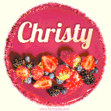 Beautifully decorated red velvet berry birthday cake with vibrant fruits and a glowing 'Christy' name, adding a touch of sweetness and sparkle.