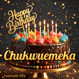 Bold golden lettering spelling Chukwuemeka on a gourmet chocolate cake decorated with small colorful candies at the base.
