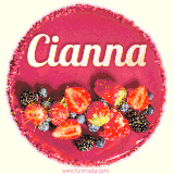 Beautifully decorated red velvet berry birthday cake with vibrant fruits and a glowing 'Cianna' name, adding a touch of sweetness and sparkle.