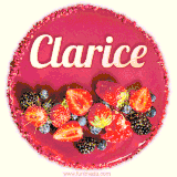 Beautifully decorated red velvet berry birthday cake with vibrant fruits and a glowing 'Clarice' name, adding a touch of sweetness and sparkle.