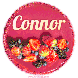 Beautifully decorated red velvet berry birthday cake with vibrant fruits and a glowing 'Connor' name, adding a touch of sweetness and sparkle.
