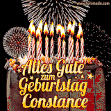 A chocolate birthday cake with glowing candles, the German text 'Alles Gute zum Geburtstag Constance,' and vibrant fireworks lighting up the background in an animated GIF.