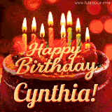 Beautifully decorated red velvet berry birthday cake with vibrant fruits and a glowing 'Cynthia' name, adding a touch of sweetness and sparkle.