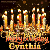 A glowing personalized birthday GIF with name Cynthia featuring lit candles with intricate designs, warm lighting, and the text 'Happy Birthday' in an elegant font.