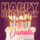 A colorful birthday cake topped with lit candles, with the words 'Happy Birthday Danuta' in bold glowing letters on a burgundy background. Animated flames add a festive touch.
