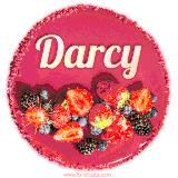 Beautifully decorated red velvet berry birthday cake with vibrant fruits and a glowing 'Darcy' name, adding a touch of sweetness and sparkle.