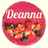 Beautifully decorated red velvet berry birthday cake with vibrant fruits and a glowing 'Deanna' name, adding a touch of sweetness and sparkle.