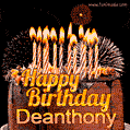 A rich chocolate cake topped with glowing birthday candles and surrounded by bright fireworks. The animated GIF displays the message 'Happy Birthday Deanthony' in golden text.