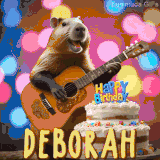 Animated birthday GIF showing a capybara playing guitar and singing beside a birthday cake with the name Deborah in large letters and colorful bokeh lights in the background.