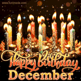 A glowing personalized birthday GIF with name December featuring lit candles with intricate designs, warm lighting, and the text 'Happy Birthday' in an elegant font.